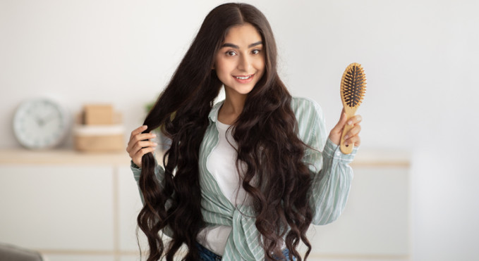 teenage girl combing her hair 